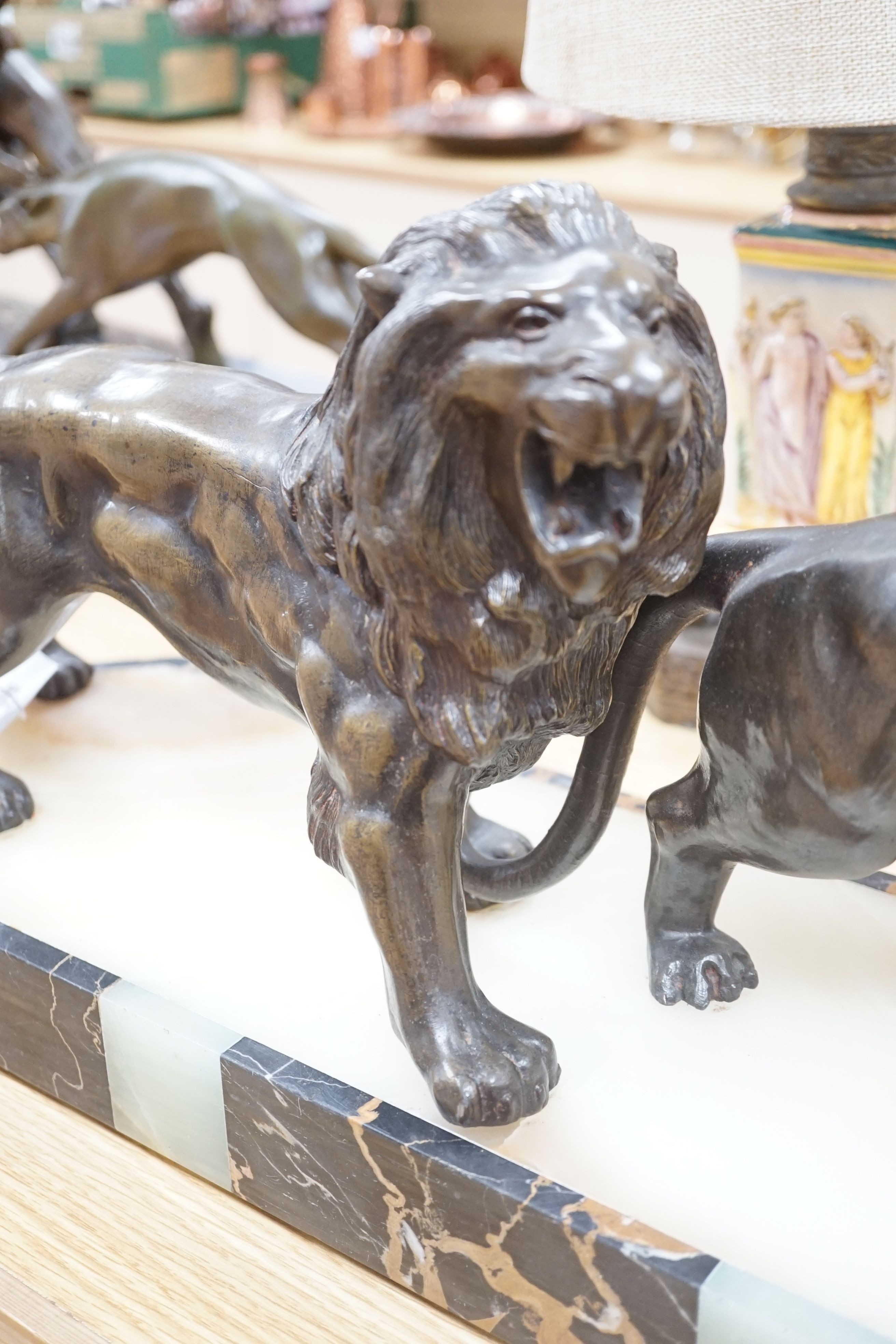 An Art Deco bronzed metal, marble and onyx group of lion and lioness, signed Benaca, 67cm